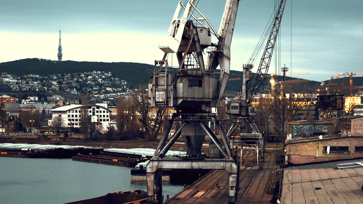 Bratislava Danube port with crane and Kamzik TV tower — ICTS Logistic has been operating on the Danube since 2011